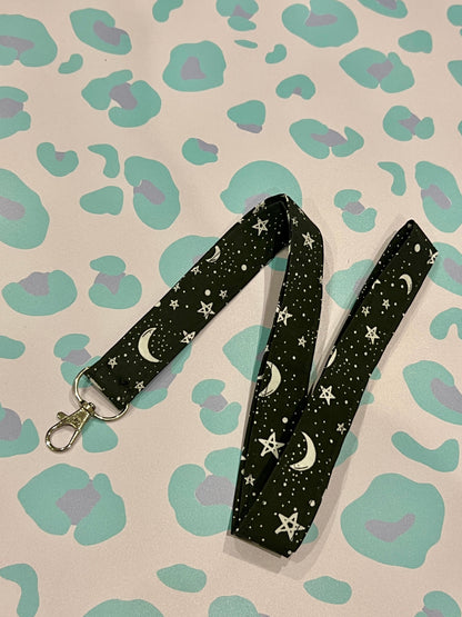Sew Much Love black fabric lanyard with white stars and crescent moons, silver lobster clasp.