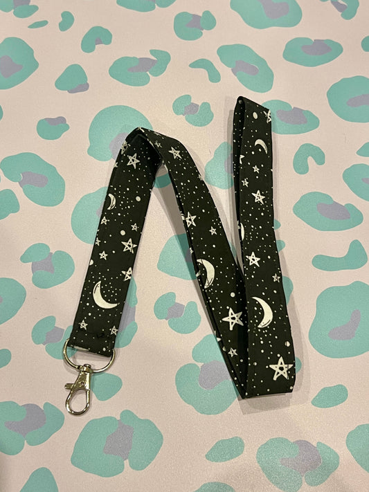 Sew Much Love black fabric lanyard with white stars and crescent moons, silver lobster clasp.