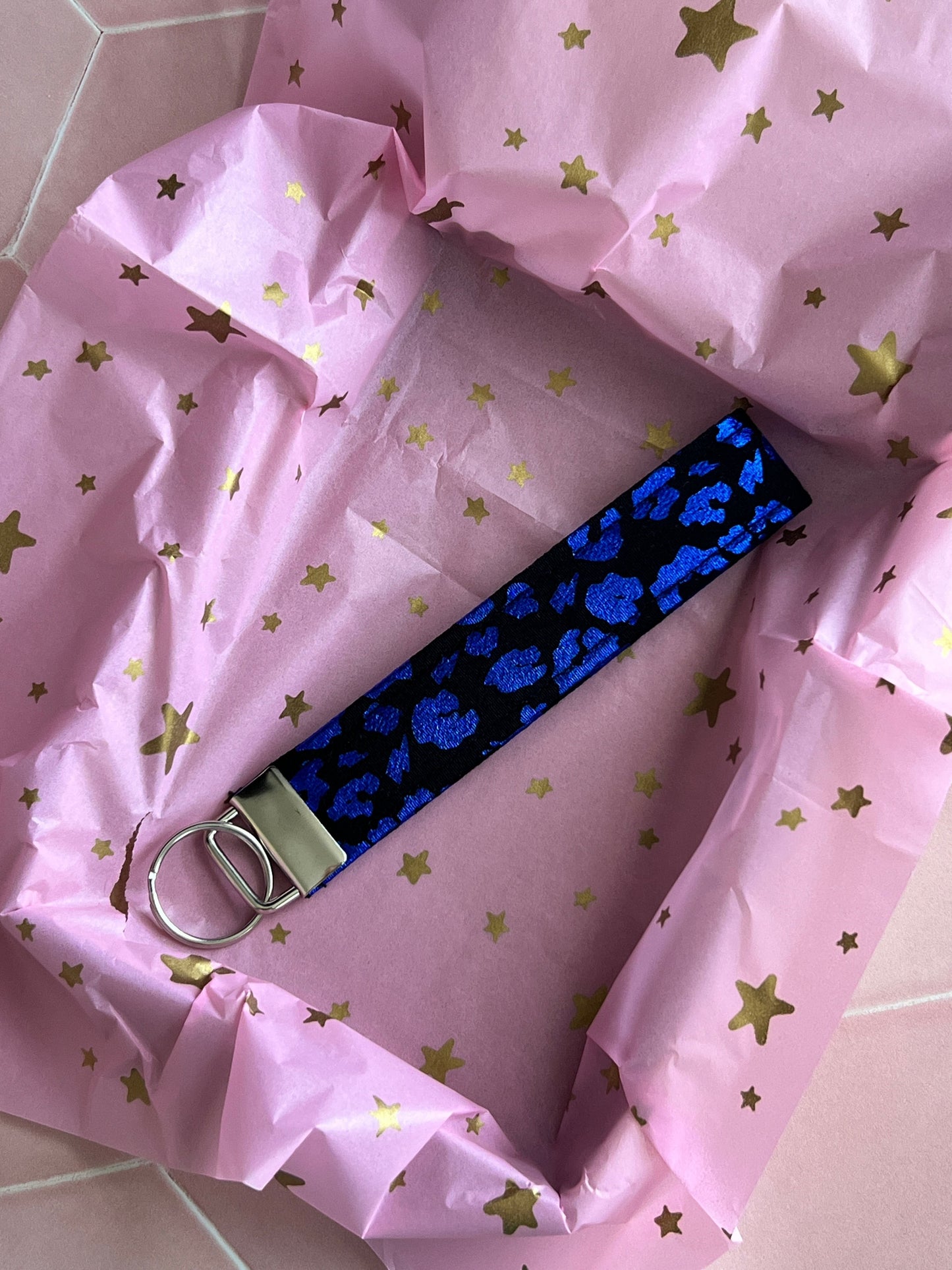 Sew Much Love black wristlet keychain with metallic blue leopard print and silver clasp.