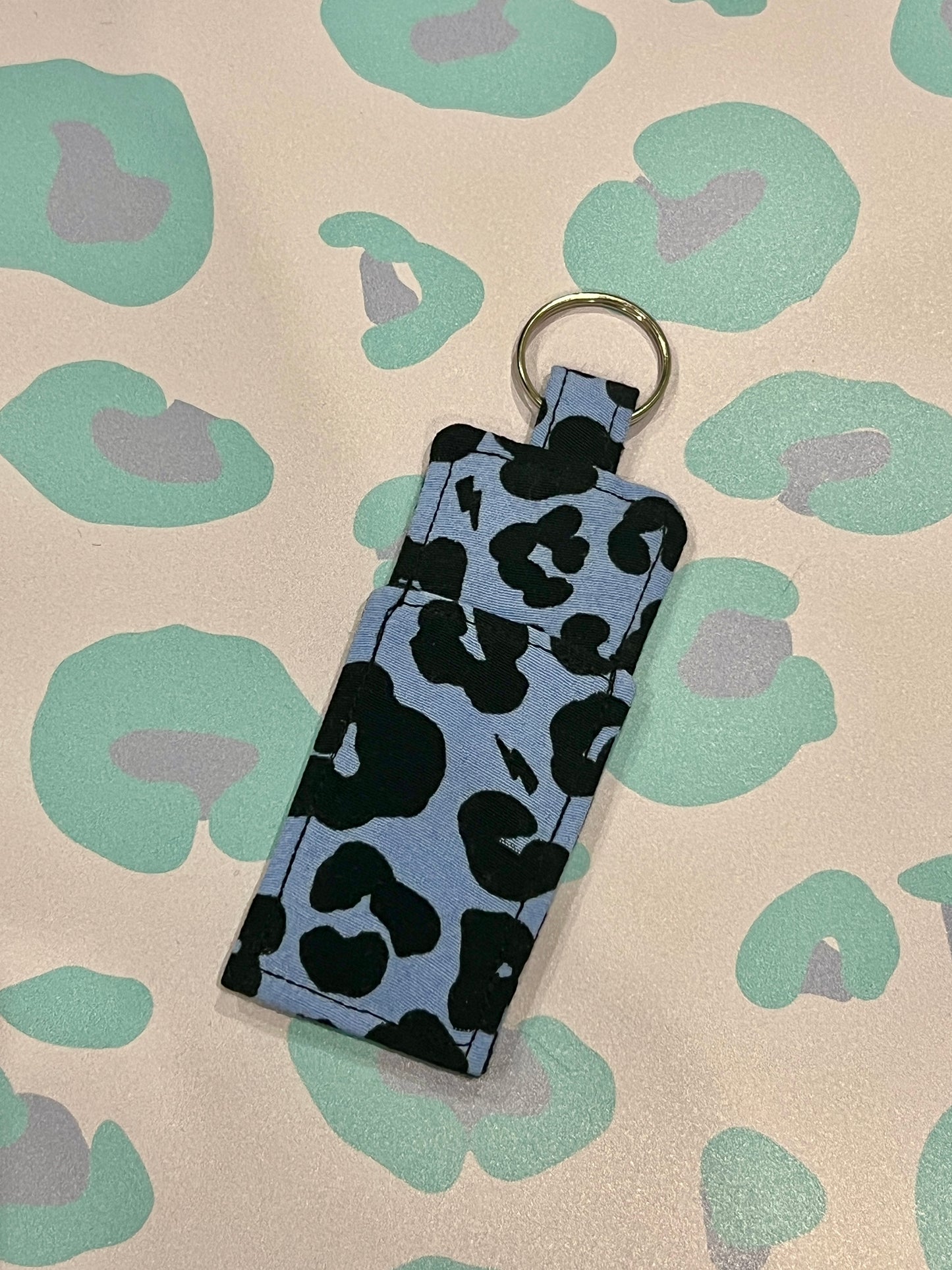 Leopard print keychain on a patterned background