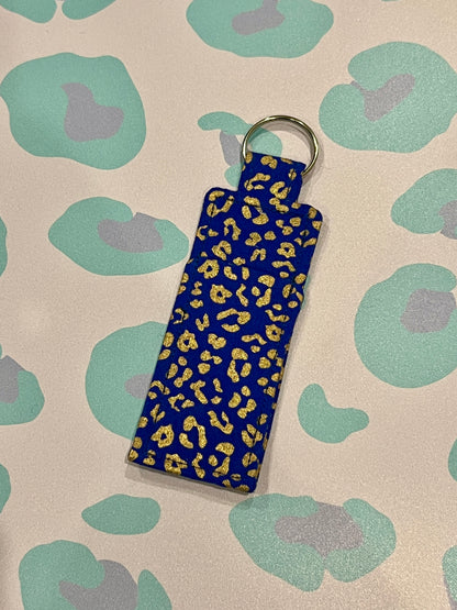 Blue keychain with yellow leopard print on a patterned background