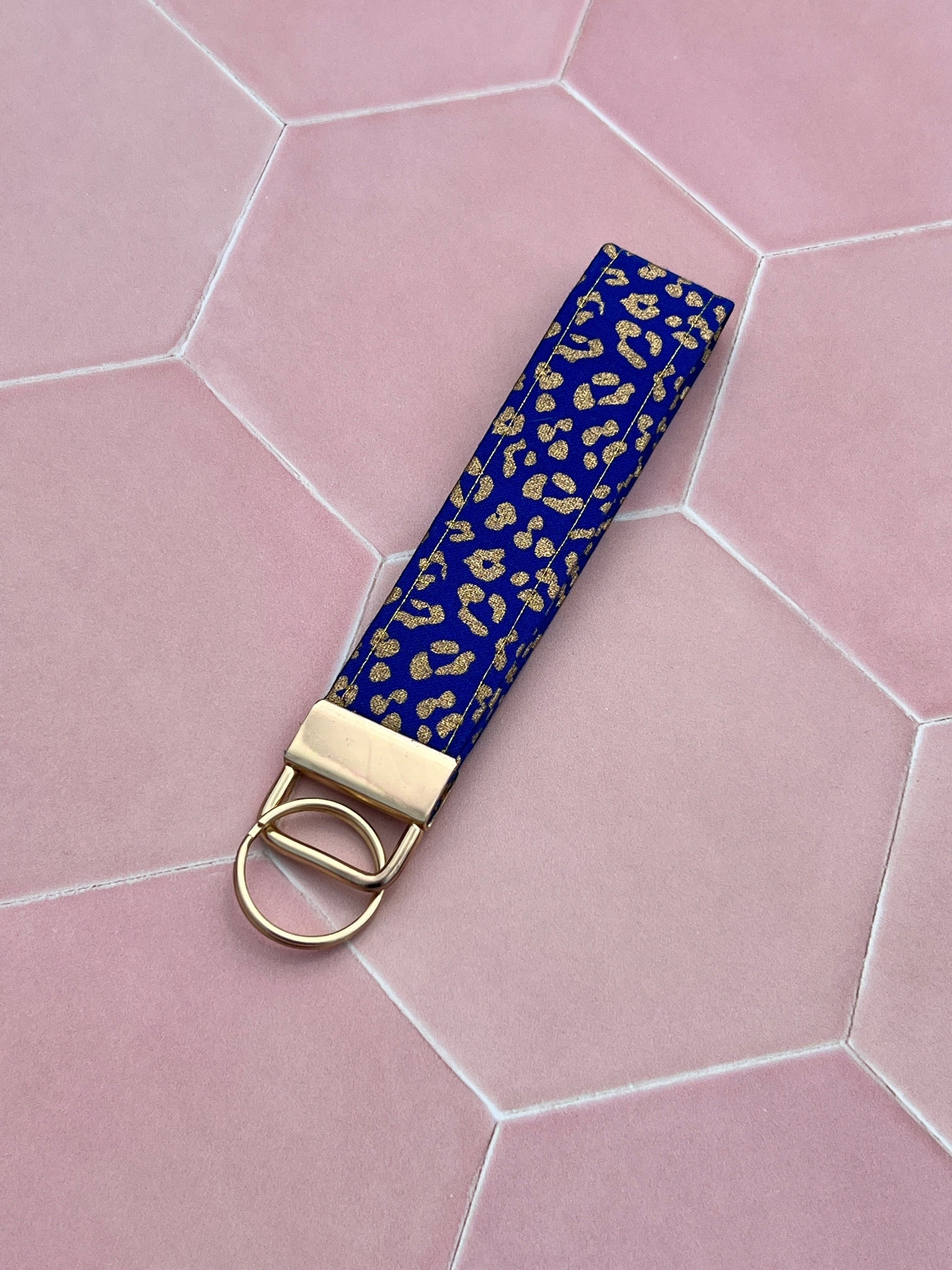 Sew Much Love blue cotton wristlet keychain with gold leopard print and gold hardware.
