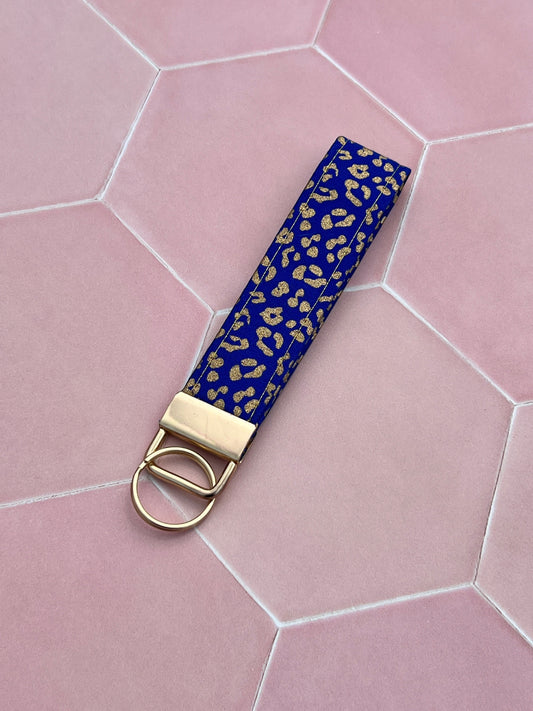 Sew Much Love blue cotton wristlet keychain with gold leopard print and gold hardware.