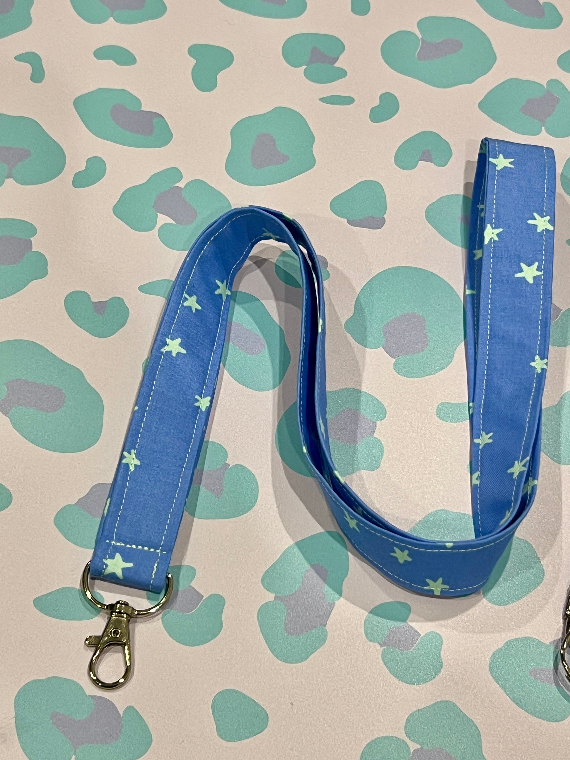 Blue lanyard with star pattern on a patterned background