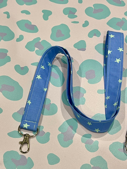 Blue lanyard with star pattern on a patterned background