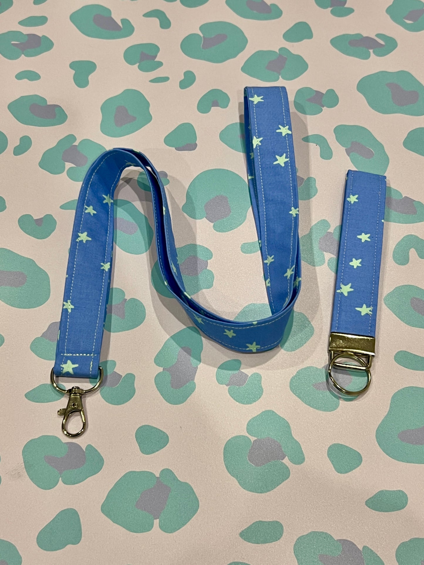 Blue lanyard with star pattern on a patterned background