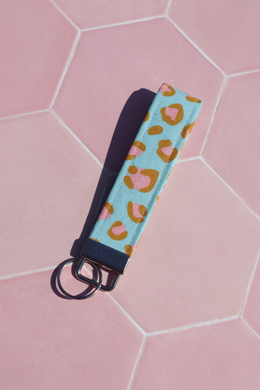 Sew Much Love blue and pink leopard print cotton wristlet keychain with silver hardware.