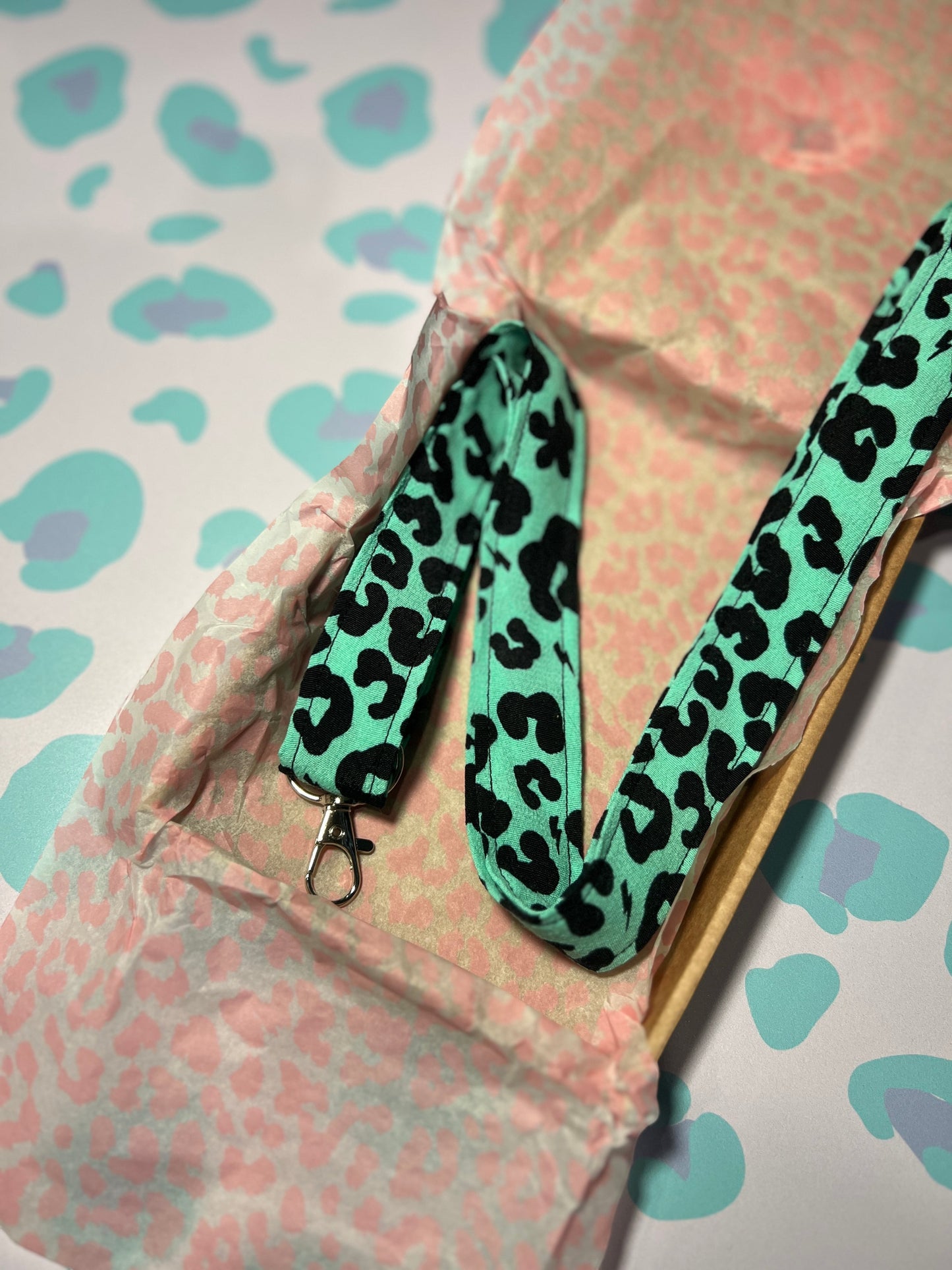 Sew Much Love green floral leopard print fabric lanyard with silver D-ring and swivel clasp for keys and ID badges.