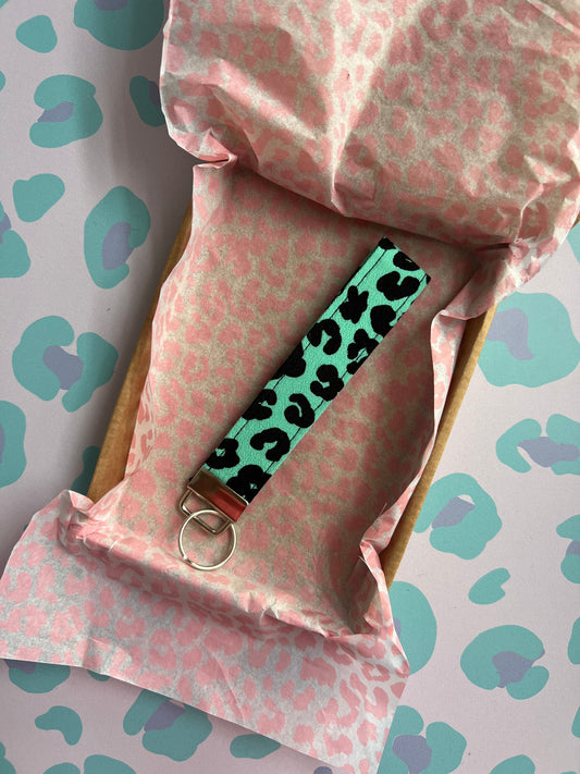 Sew Much Love green and black leopard print fabric wristlet keychain with silver hardware.