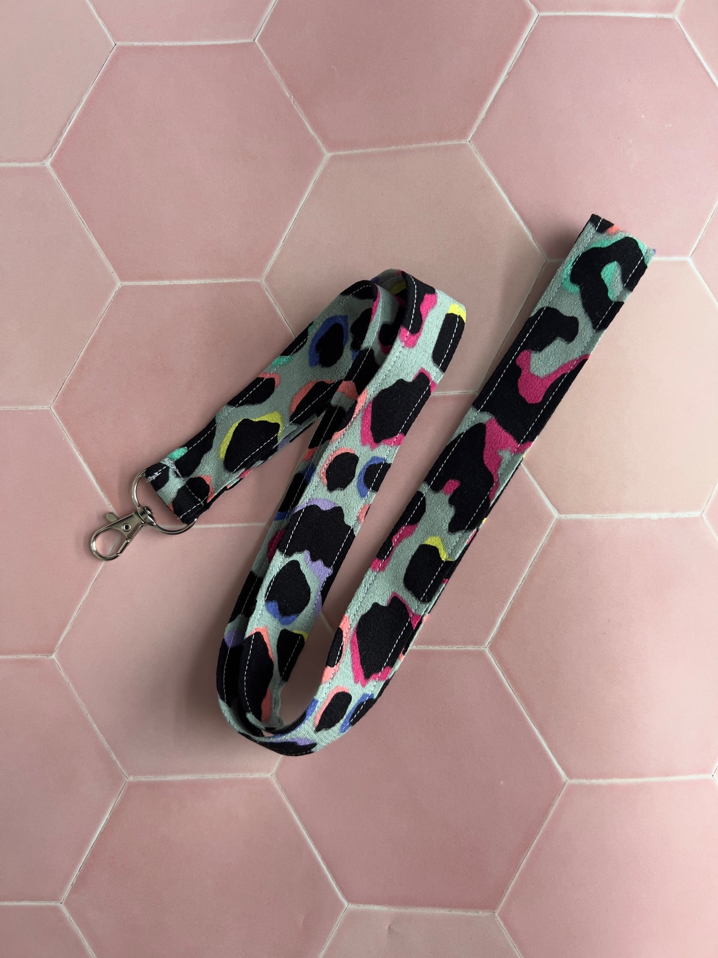 Khaki Rainbow Leopard Print Lanyard on a pink background