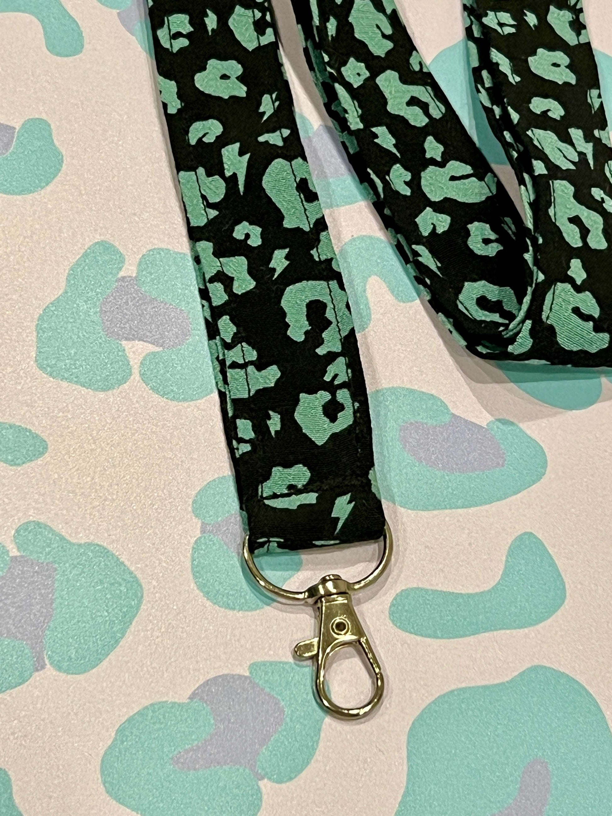 Sew Much Love black and khaki green leopard print fabric lanyard with D-ring and swivel clasp.
