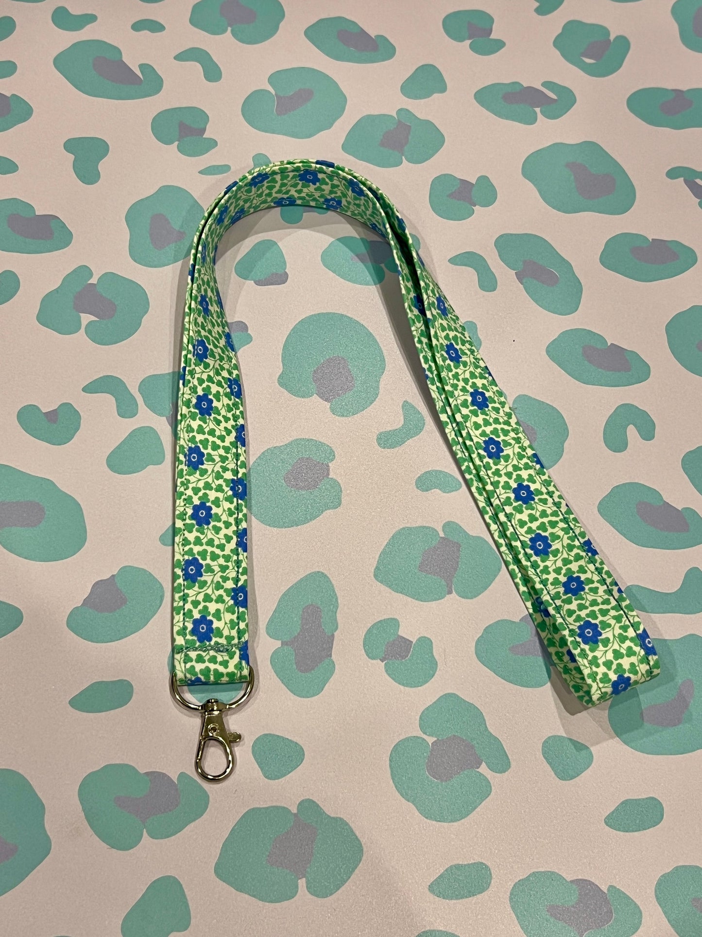 Sew Much Love Liberty blue floral and green leaf print lanyard with silver clasp.