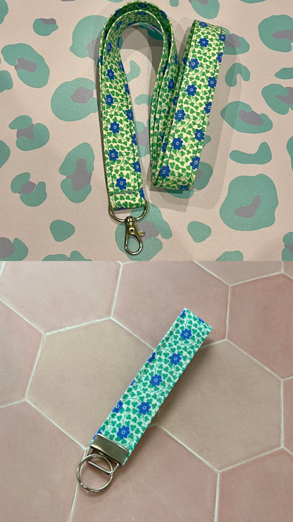 Green floral lanyard and keychain on a patterned surface