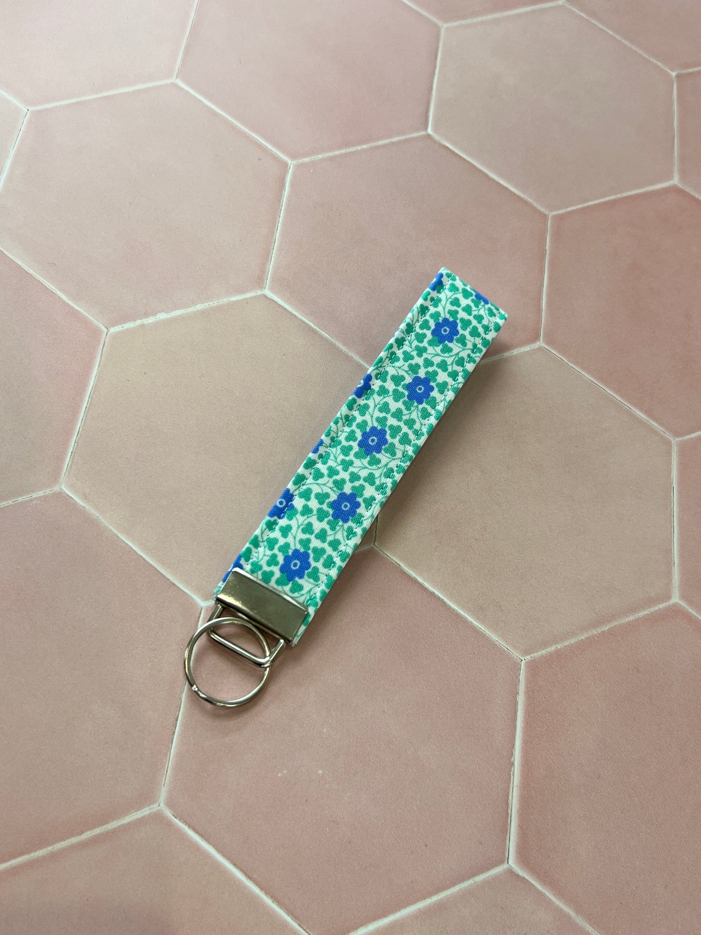 Sew Much Love blue and green floral print cotton wristlet keychain with silver hardware.