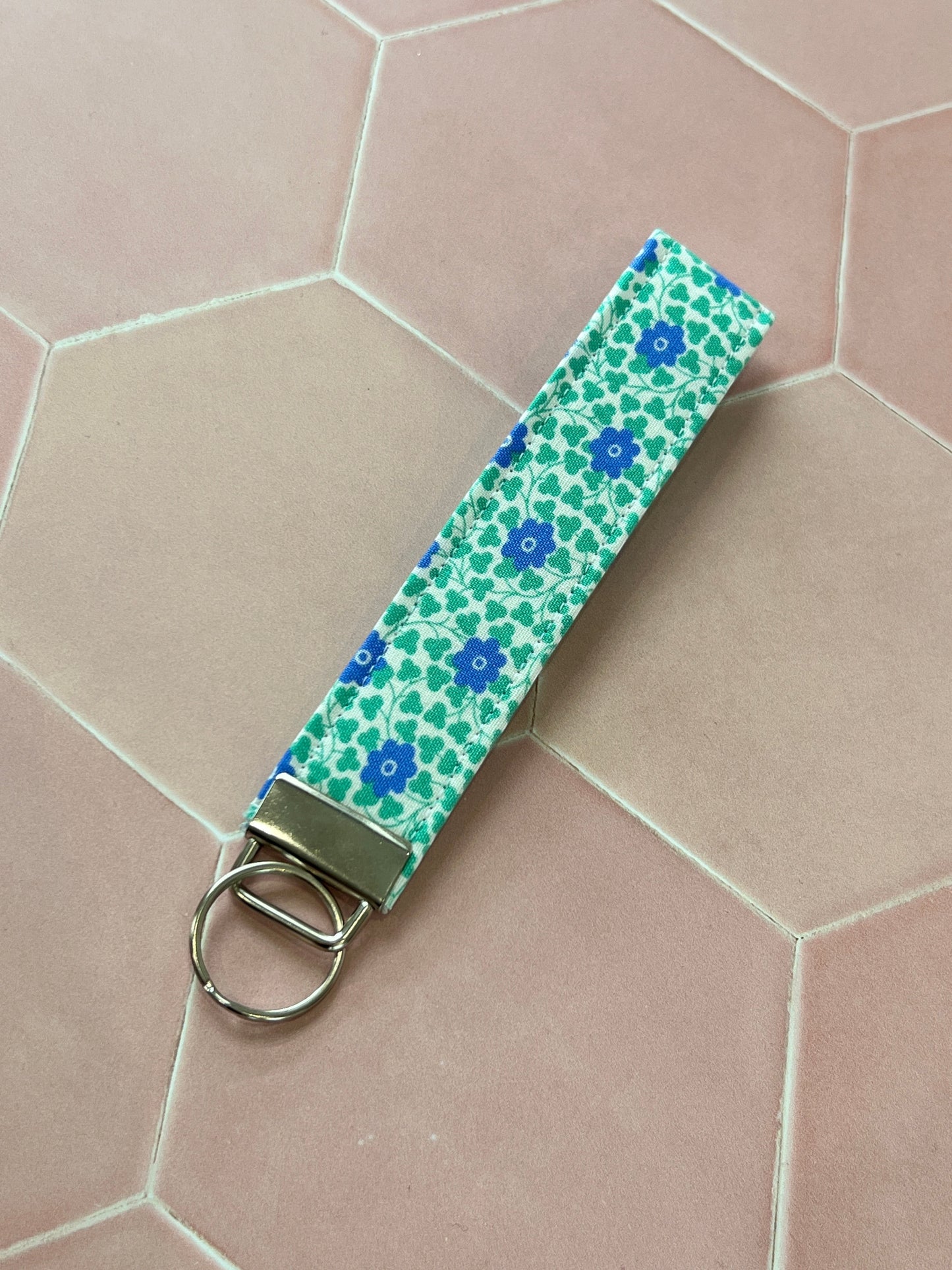 Sew Much Love blue and green floral cotton wristlet keychain with silver hardware.