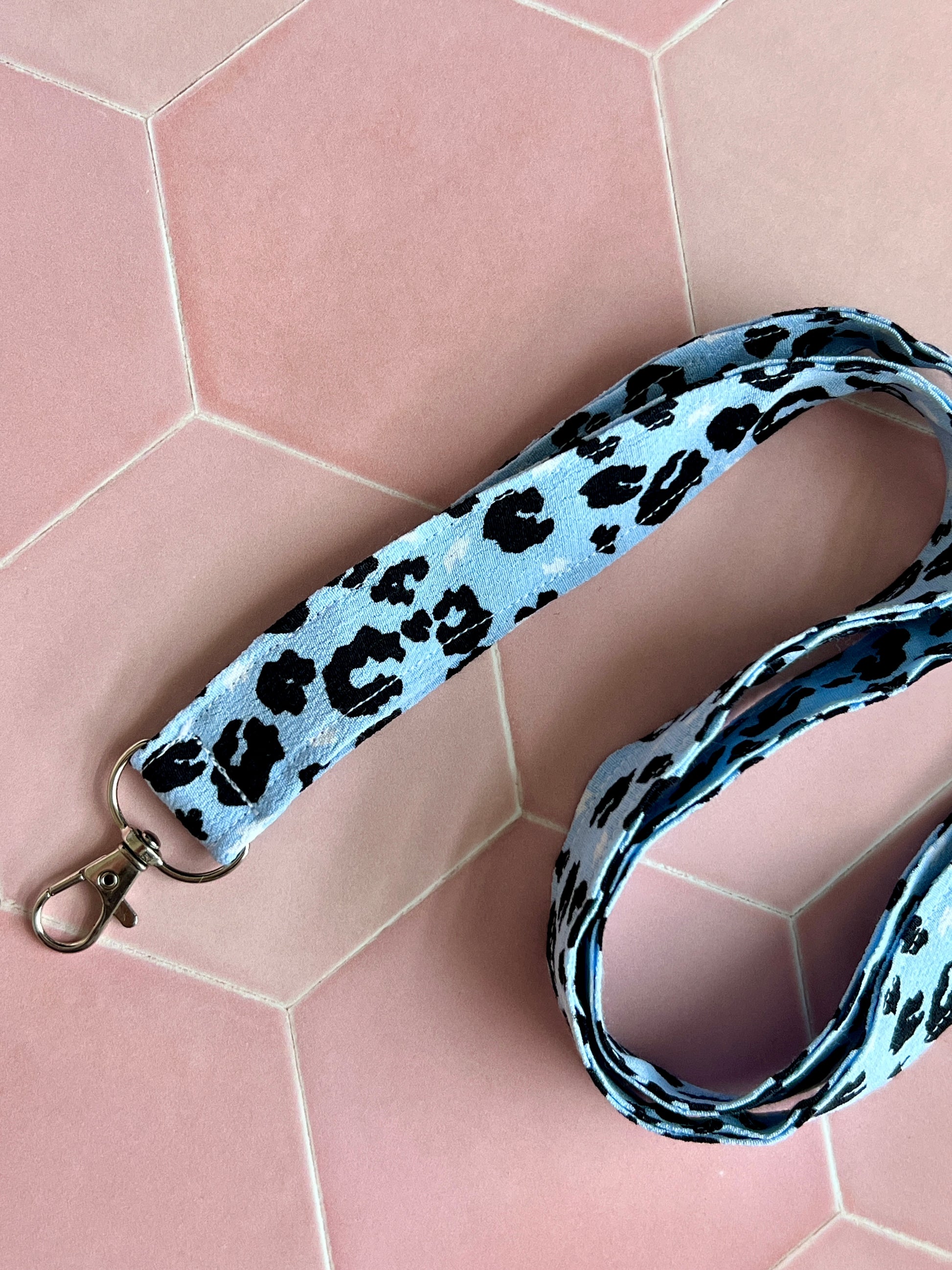 Close-up of handmade light blue leopard print lanyard, perfect for carrying keys, badges, and wallets securely