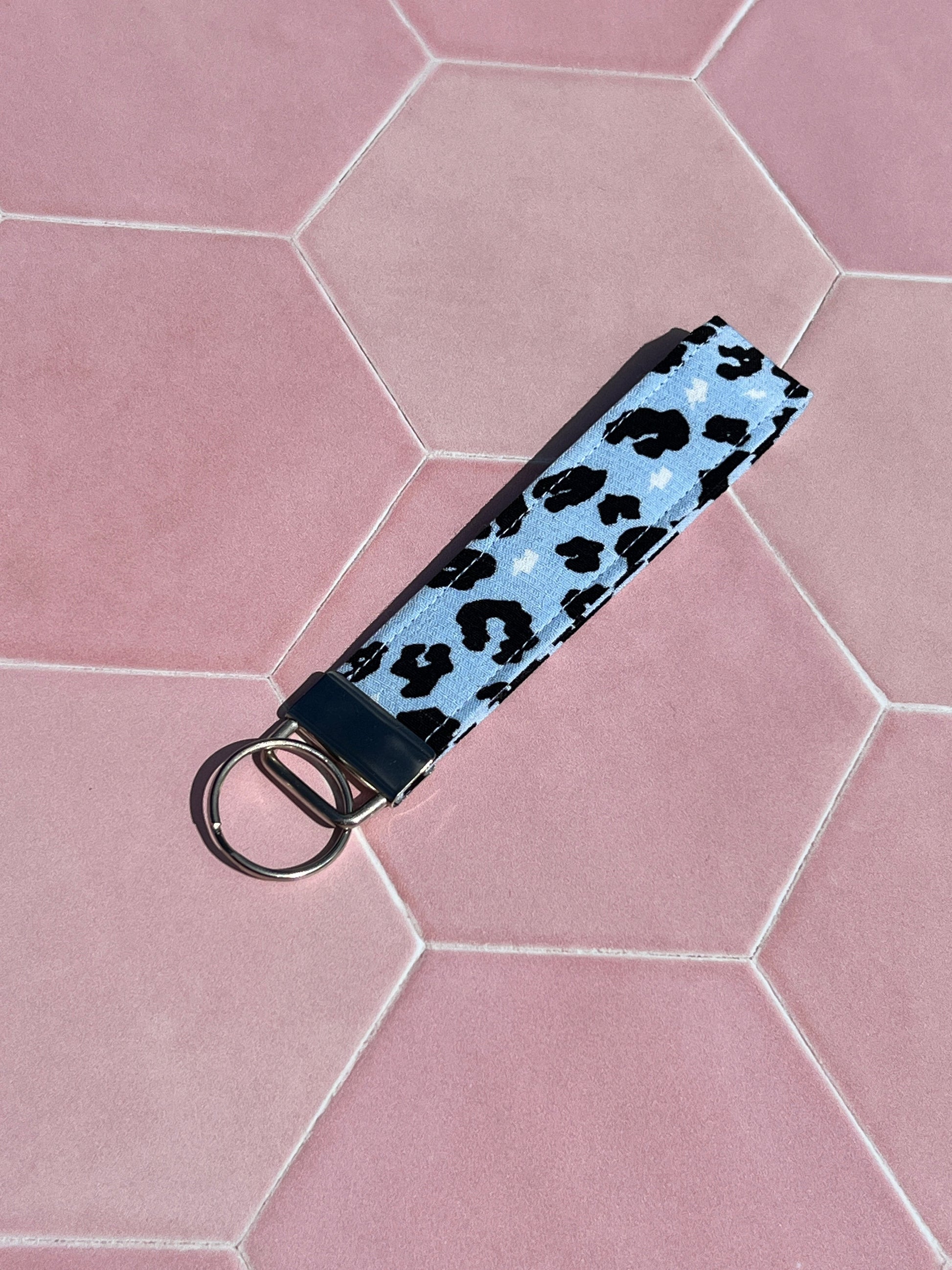 Sew Much Love light blue wristlet keychain with black leopard print and silver hardware. Made from cotton.