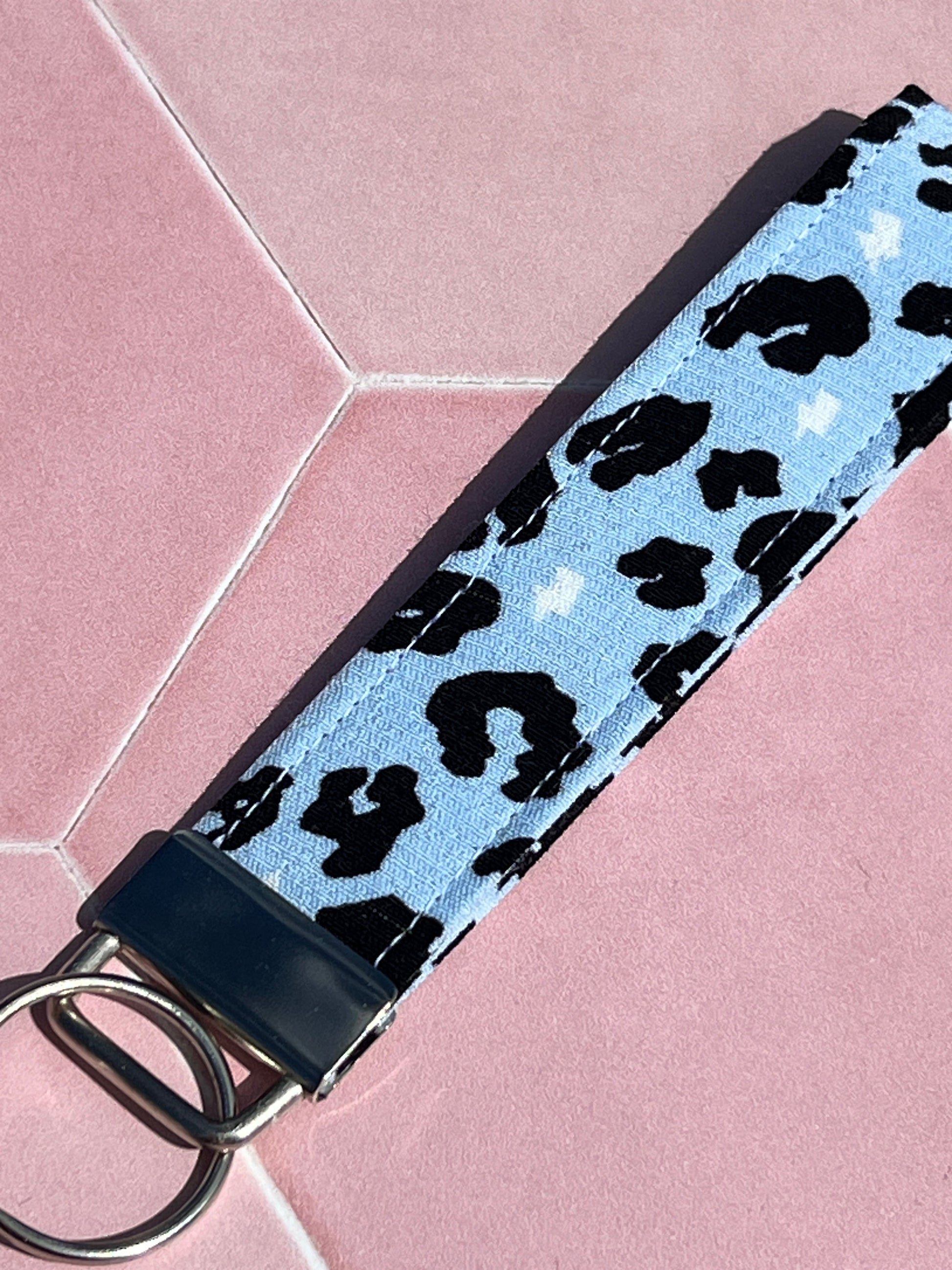 Sew Much Love light blue cotton wristlet keychain with black leopard print and white lightning bolts.