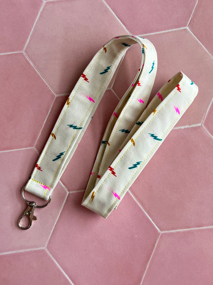 Handmade lanyard with colourful lightning print on cream fabric, metal D-ring, ideal for everyday essentials and gifts