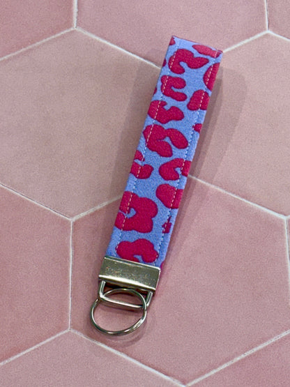 Sew Much Love lilac and pink leopard print fabric wristlet keychain with silver hardware.