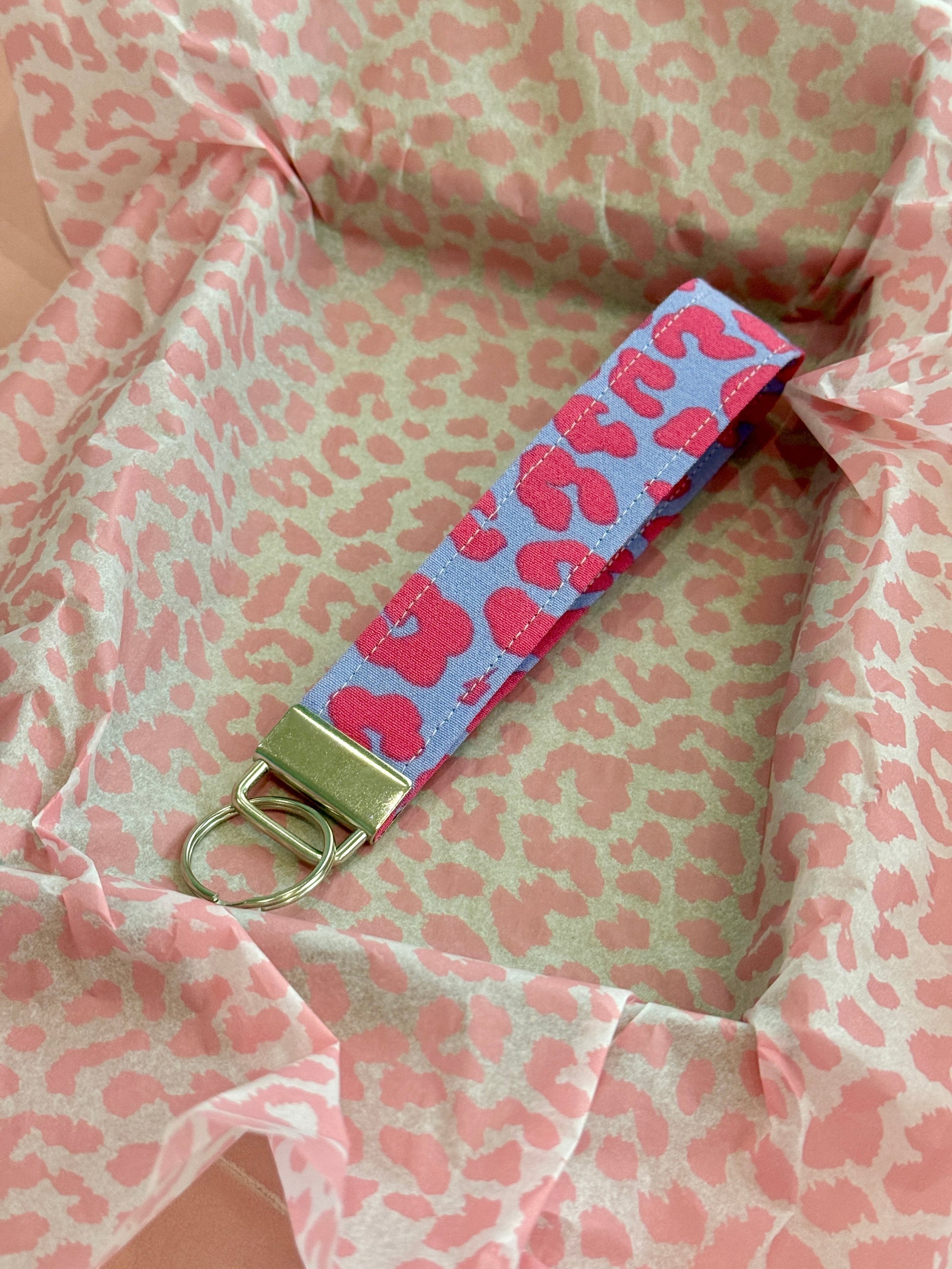Sew Much Love lilac and pink leopard print fabric wristlet keychain with silver hardware.