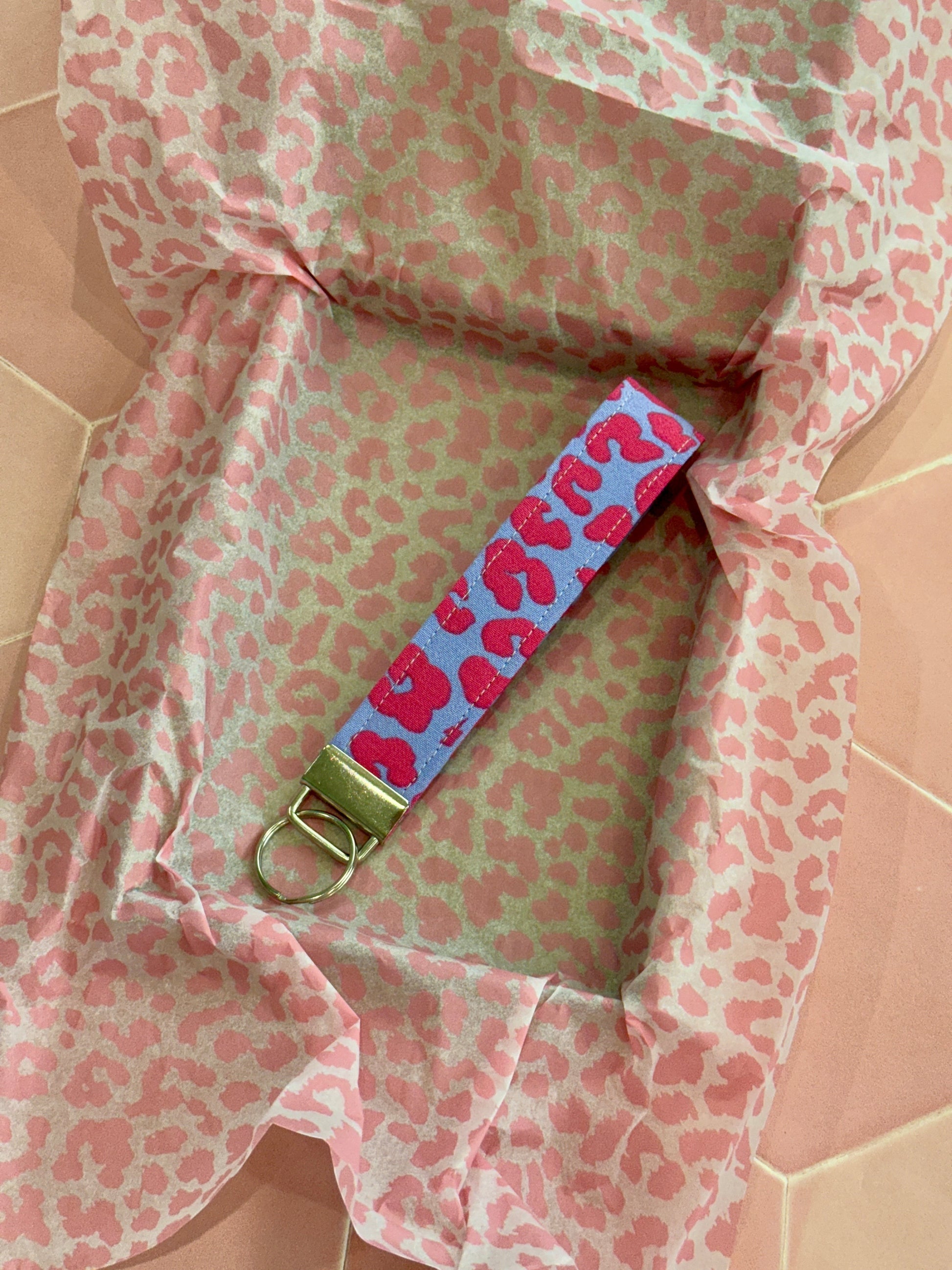 Sew Much Love lilac and pink leopard print fabric wristlet keychain with silver hardware.