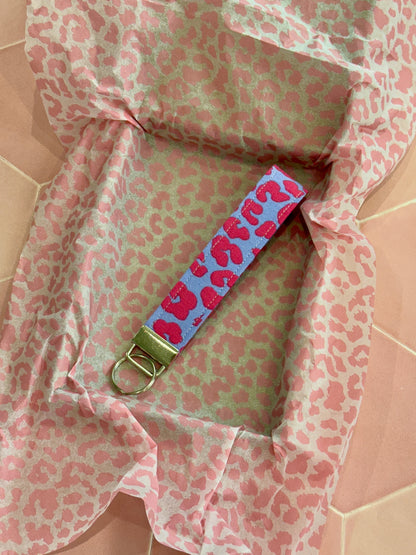 Sew Much Love lilac and pink leopard print fabric wristlet keychain with silver hardware.