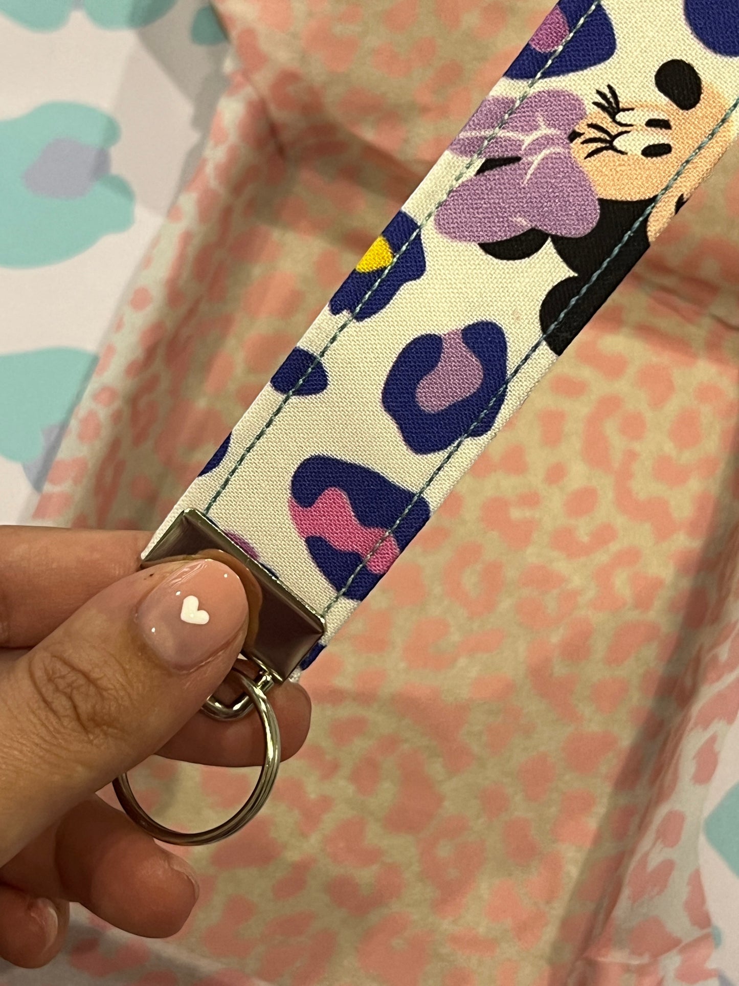 Sew Much Love pastel leopard print wristlet keychain with Minnie graphic and silver hardware.