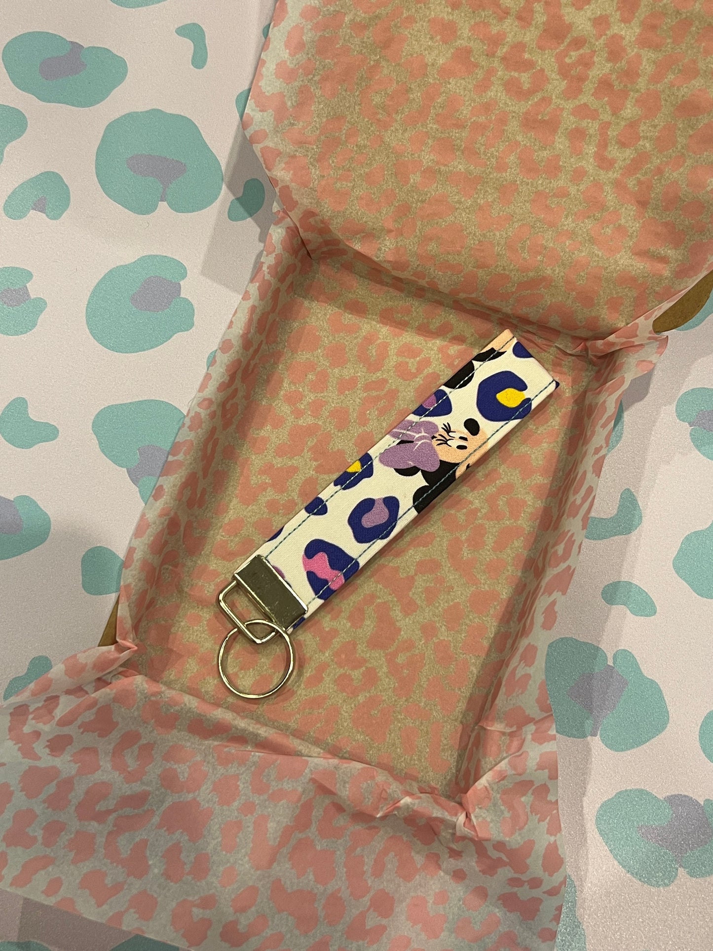 Sew Much Love pastel leopard print wristlet keychain with Minnie graphic, cotton, silver hardware.