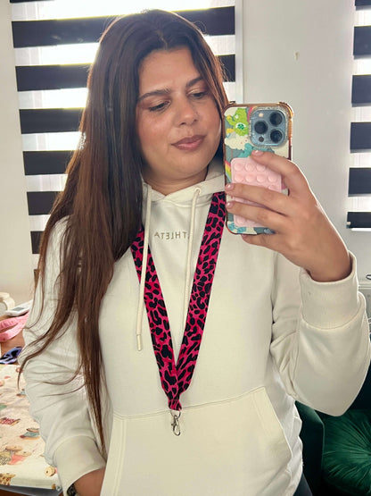 Brand owner Elana wearing a white hoodie with a colourful Pink with Black Wild Leopard Print Lanyard.