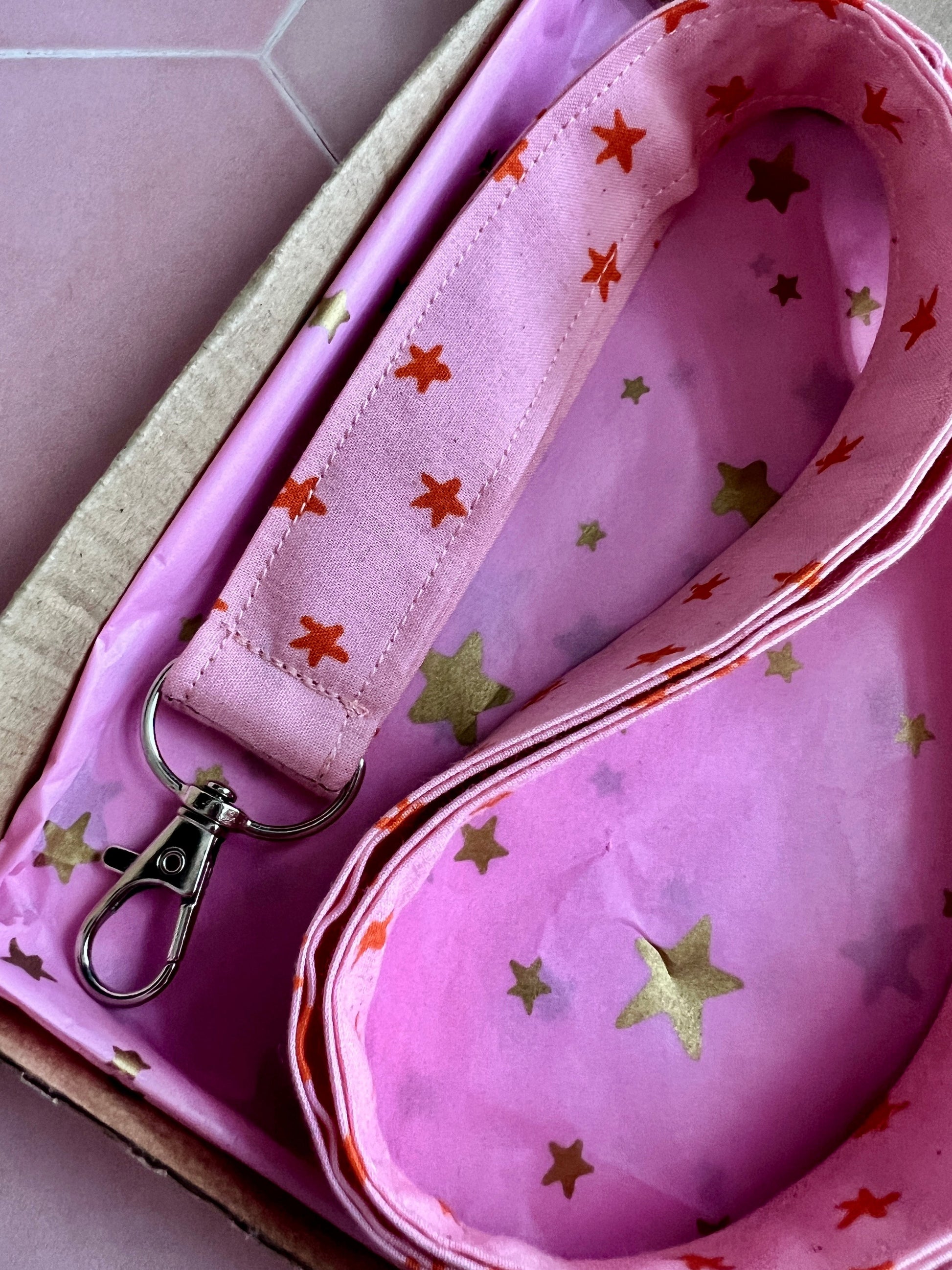 Sew Much Love pink fabric lanyard with orange stars and a silver D-ring, perfect for keys and ID badges.
