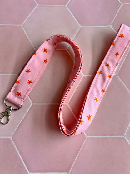 Pink lanyard with orange star design, D-ring key holder, handmade small business gift for teachers and nurses UK