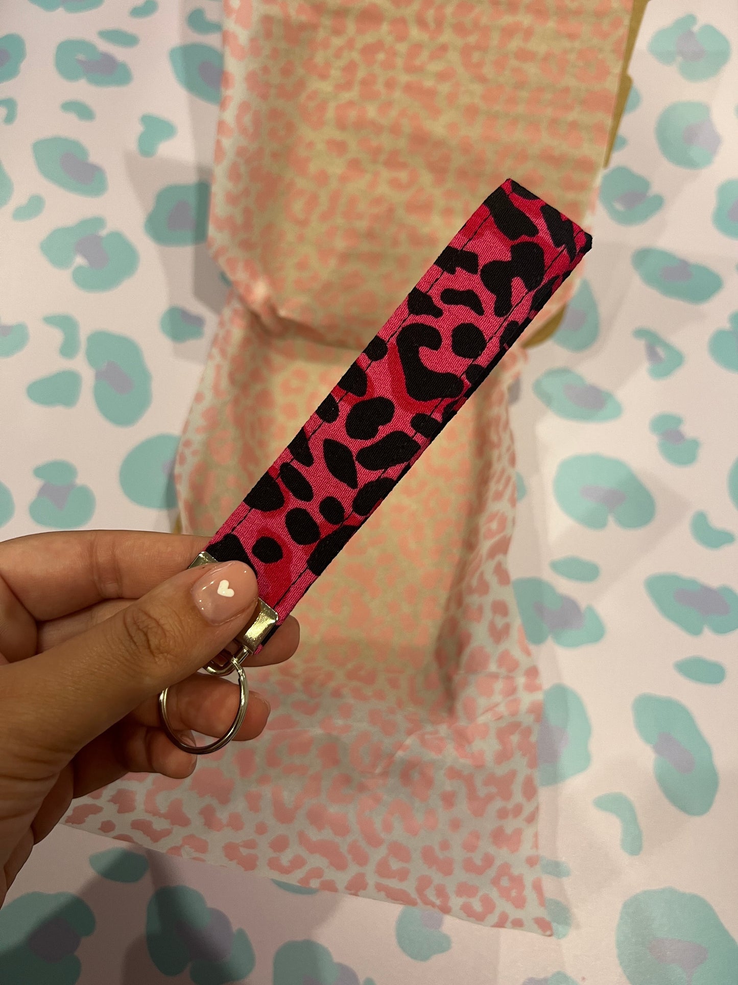 Sew Much Love pink and black wild leopard print fabric wristlet keychain with silver hardware.