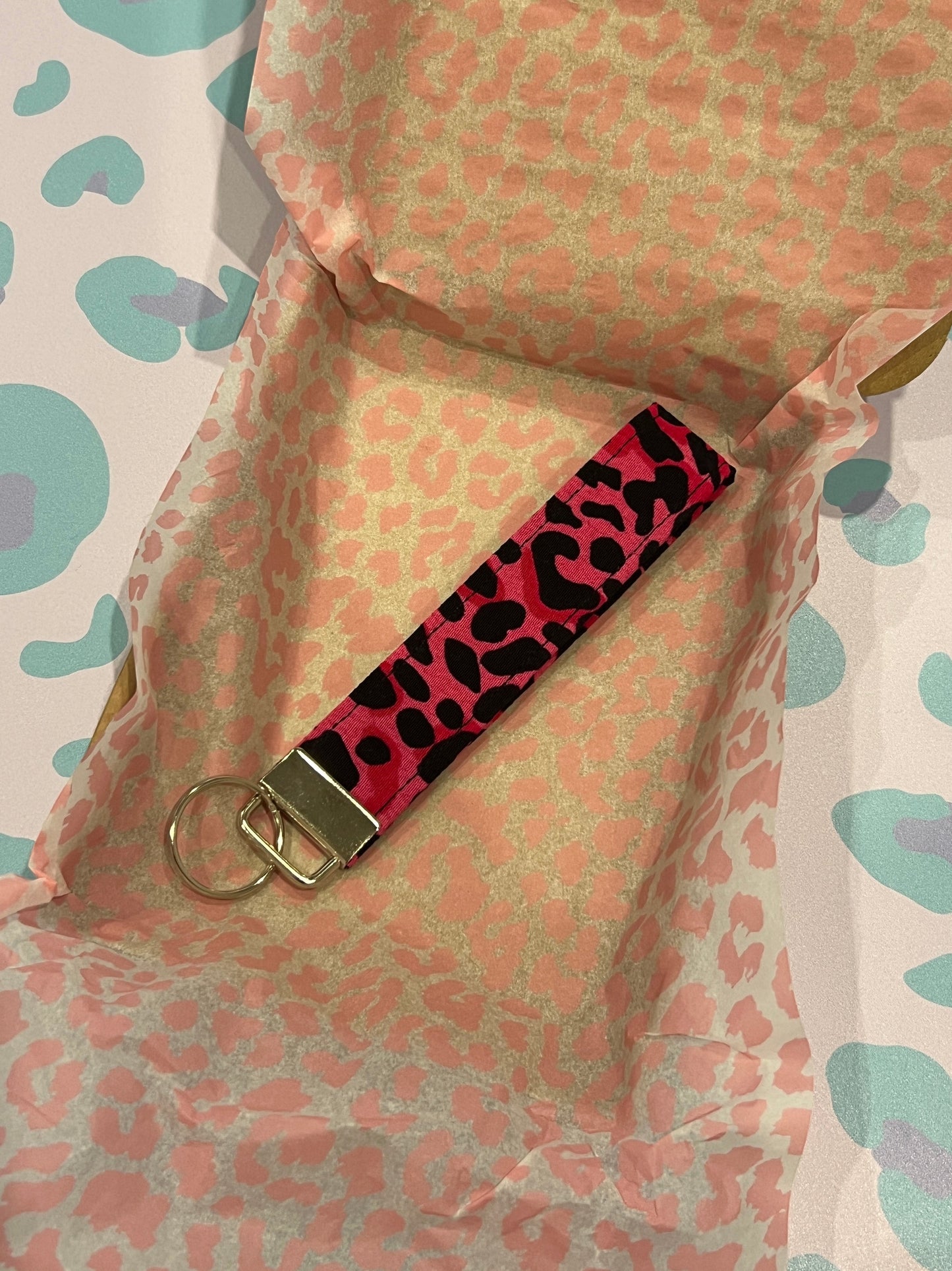 Sew Much Love pink and black wild leopard print fabric wristlet keychain with silver hardware.