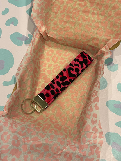 Sew Much Love pink and black wild leopard print fabric wristlet keychain with silver hardware.