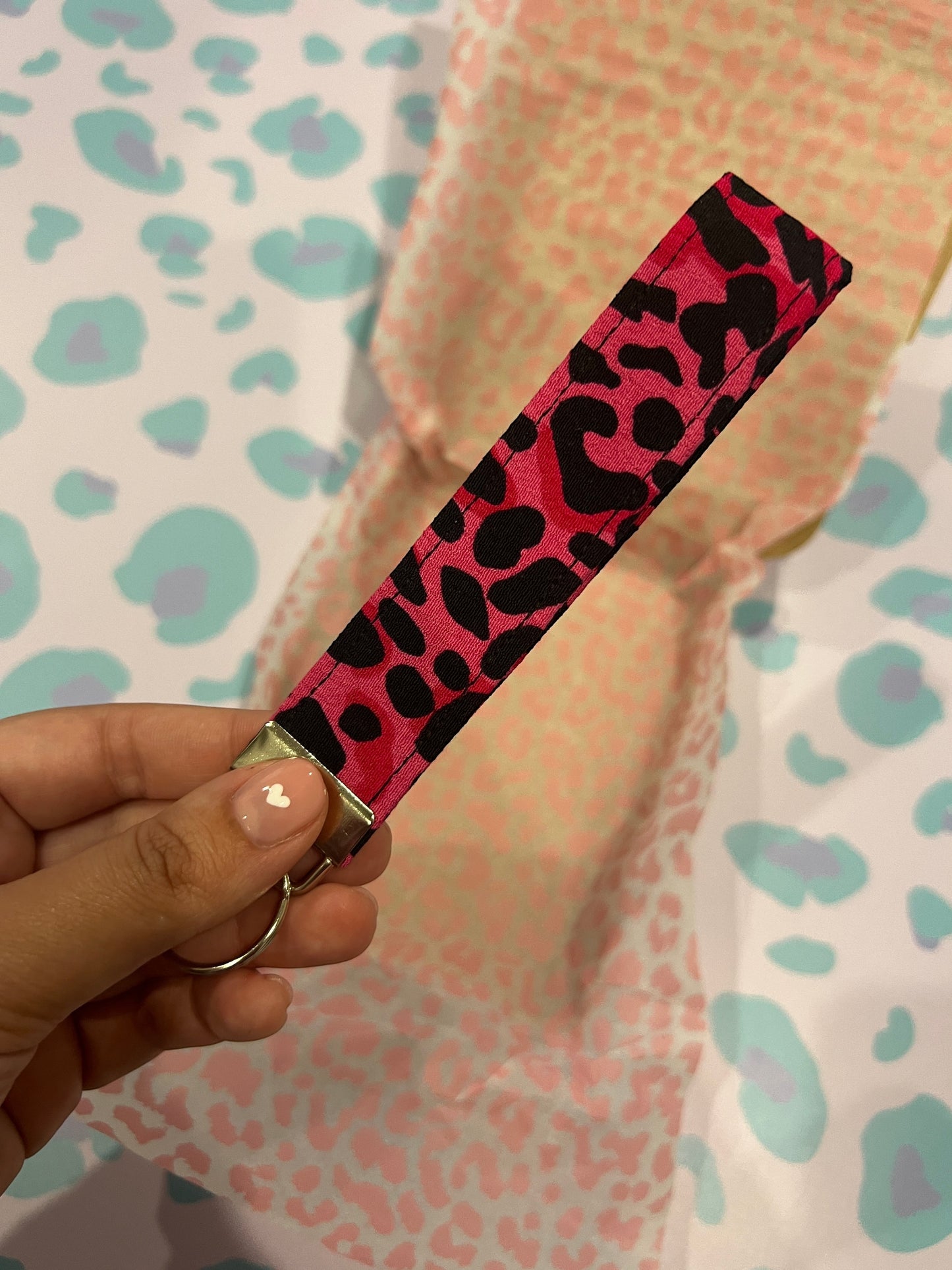 Sew Much Love pink and black wild leopard print fabric wristlet keychain with silver hardware.