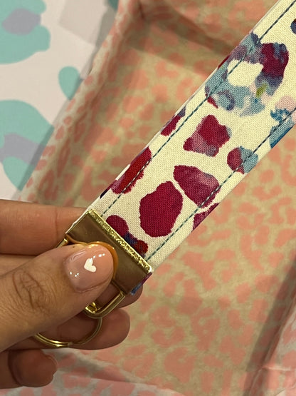 Sew Much Love rainbow tie-dye leopard print cotton wristlet with gold hardware and keyring.