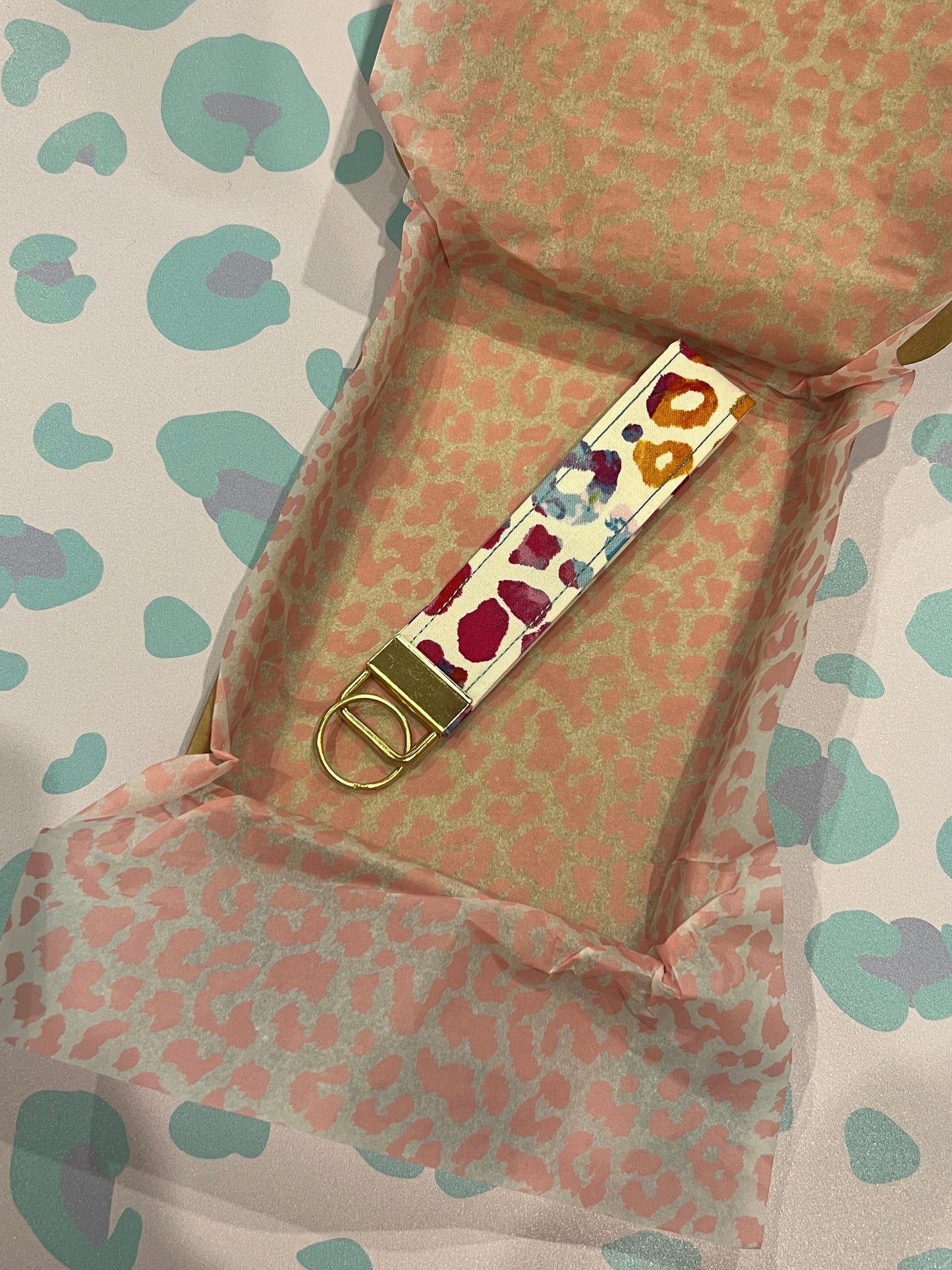 Sew Much Love rainbow tie-dye leopard print wristlet with gold hardware. Cotton fabric, unique print.