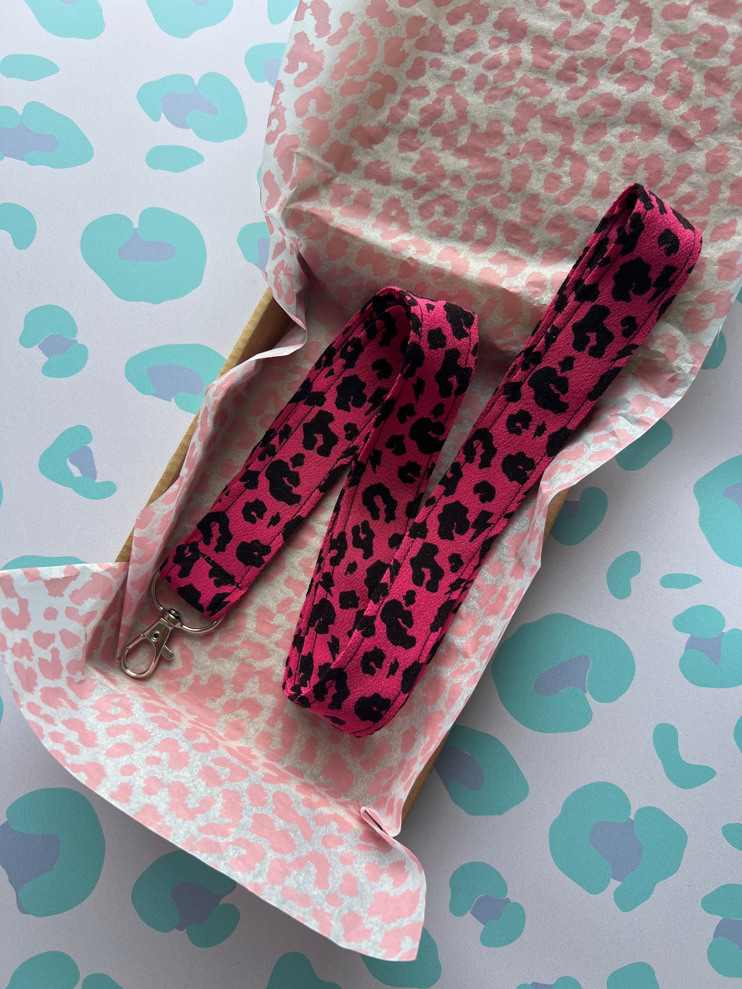 Sew Much Love raspberry pink and black leopard print fabric lanyard with D-ring and swivel clasp.