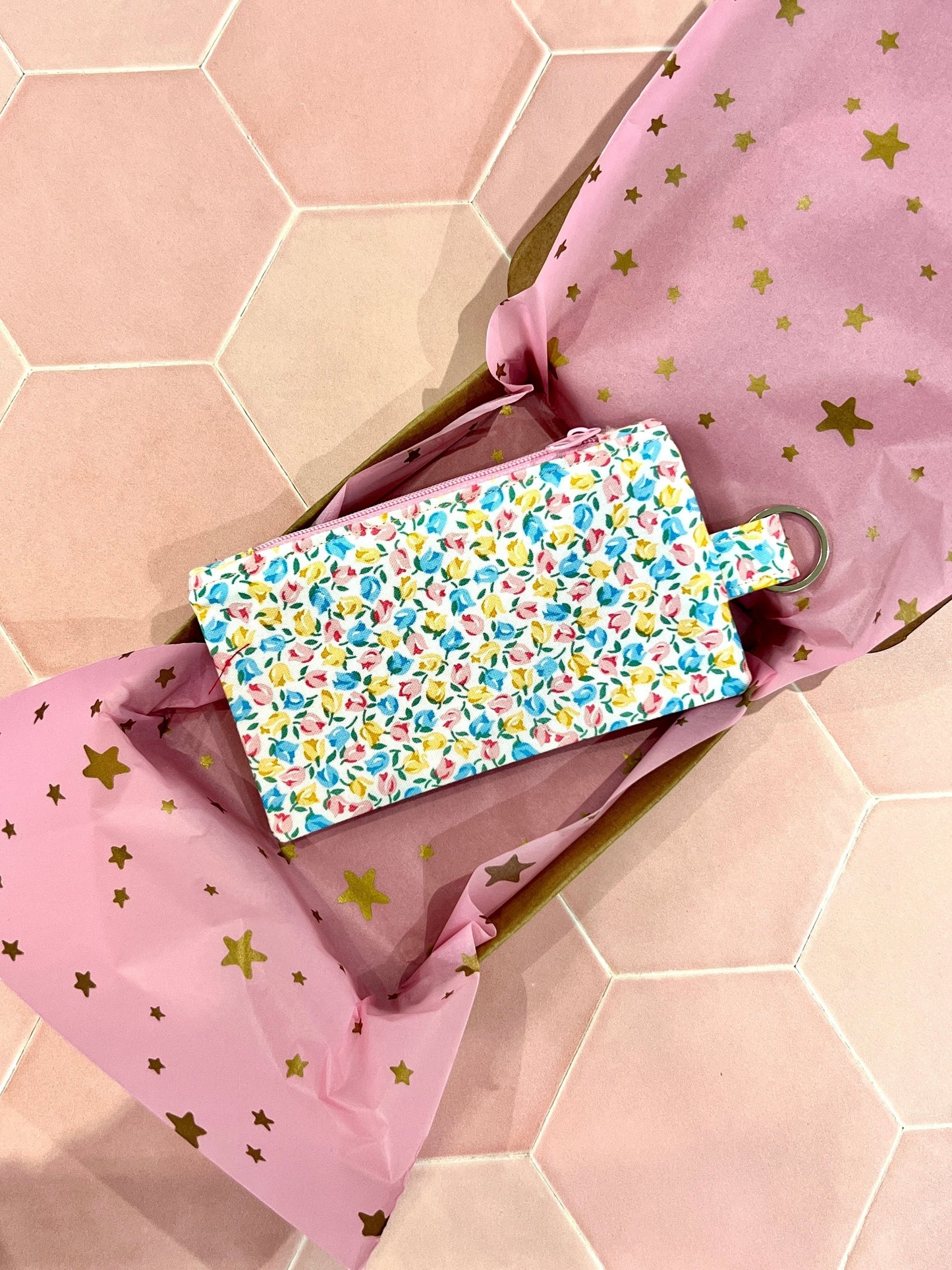 Sew Much Love coin purse with a tiny tulip print in pastel blue, yellow, and pink. Features a keyring attachment.