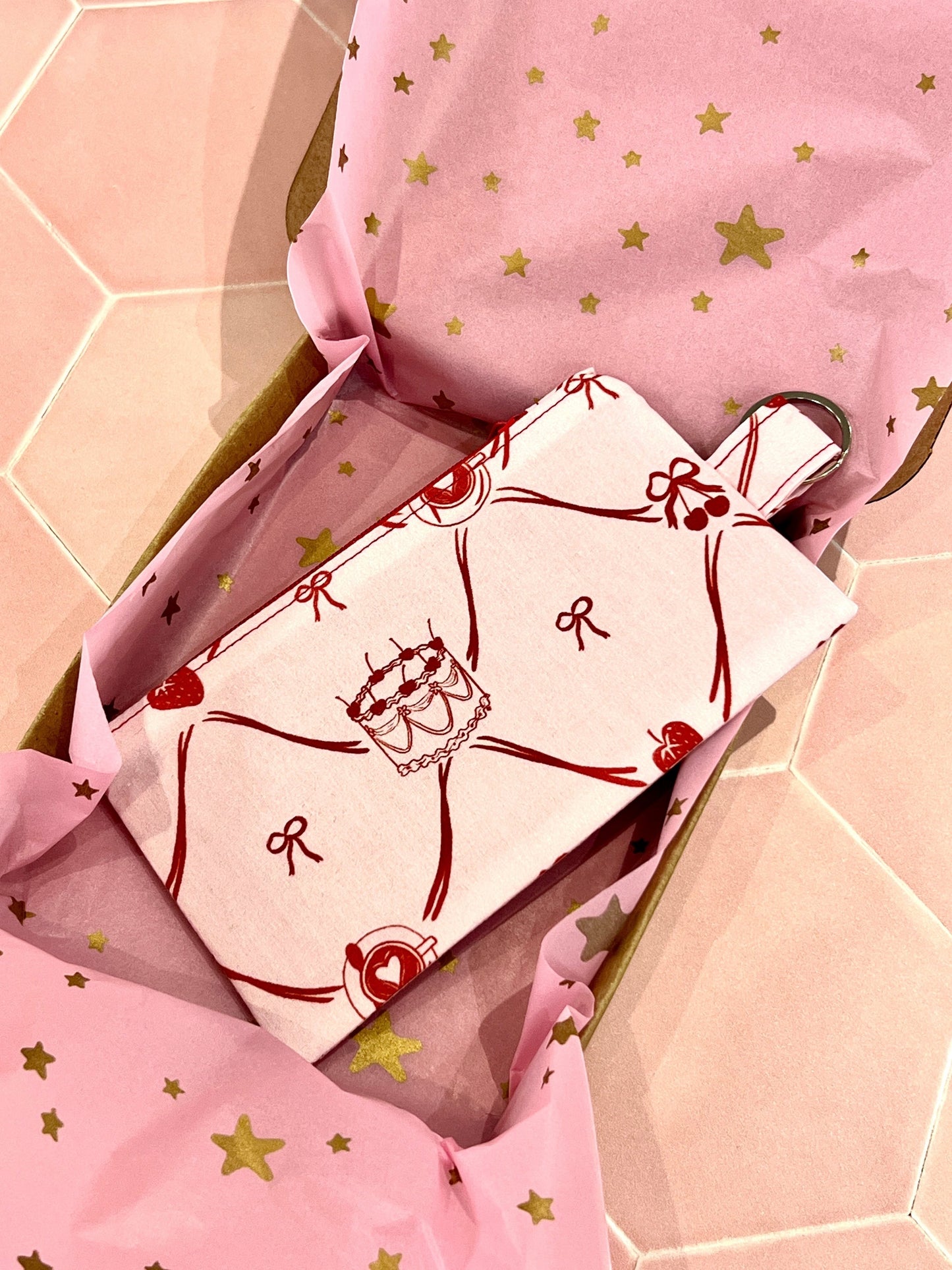 Sew Much Love Live, Laugh, Cake coin purse with cake, strawberry, and bow print on pink fabric with keyring.