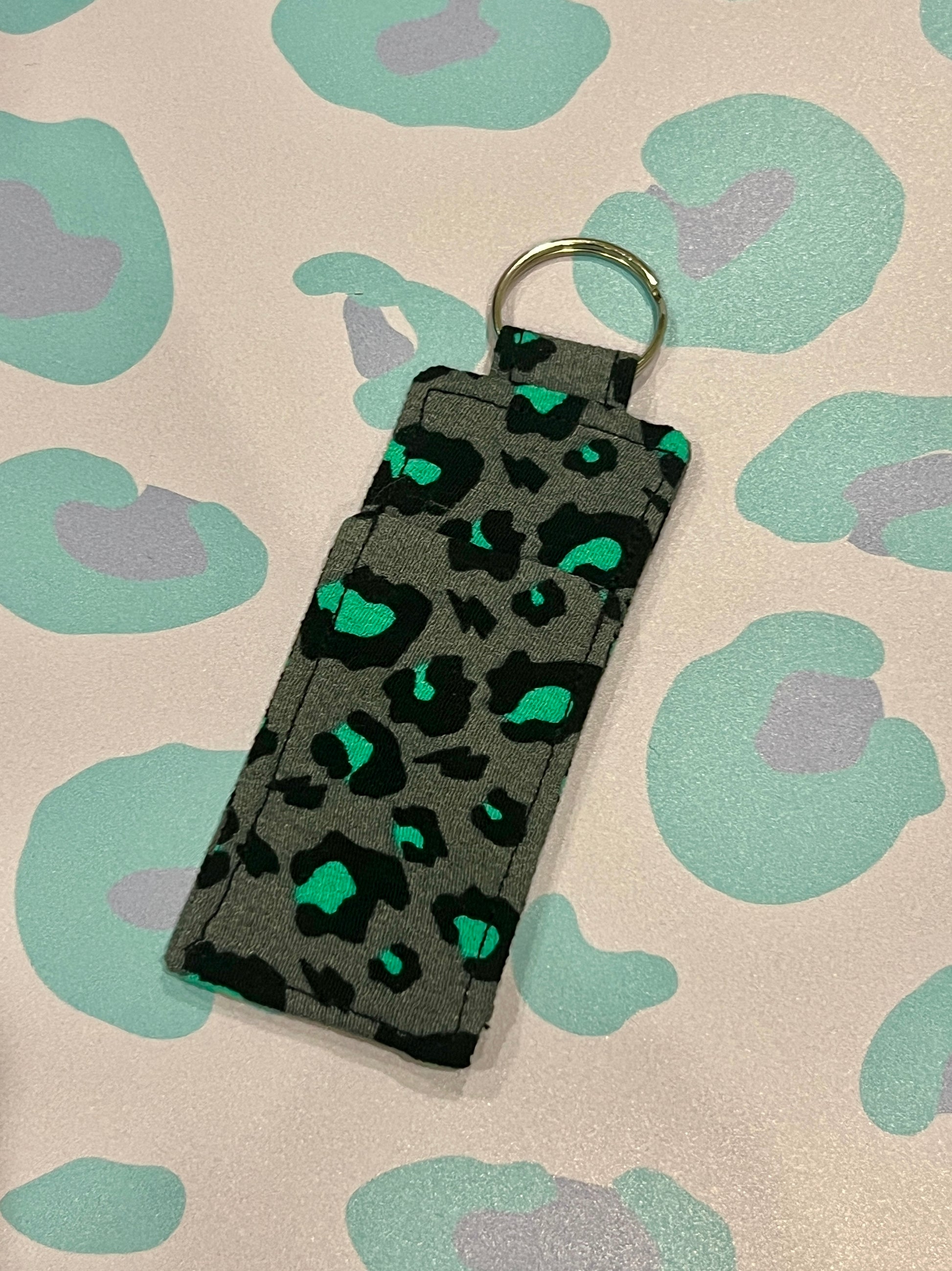 Keychain with leopard print design on a patterned background