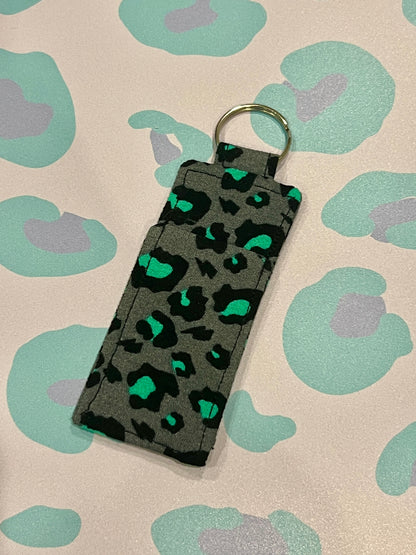 Keychain with leopard print design on a patterned background