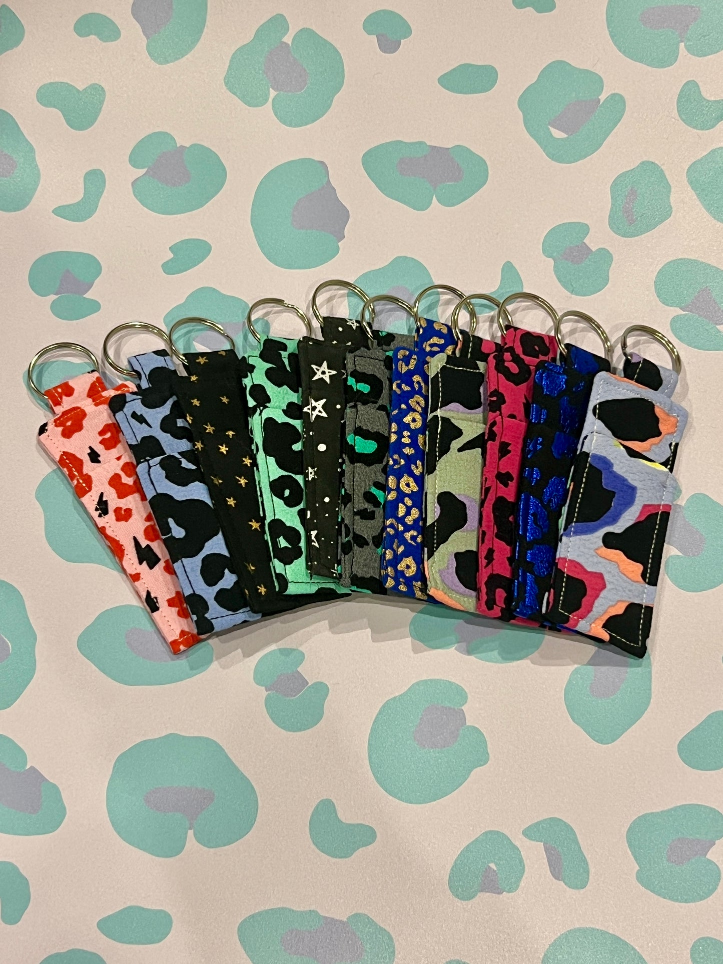 Set of colorful keychains with patterned straps on a patterned background