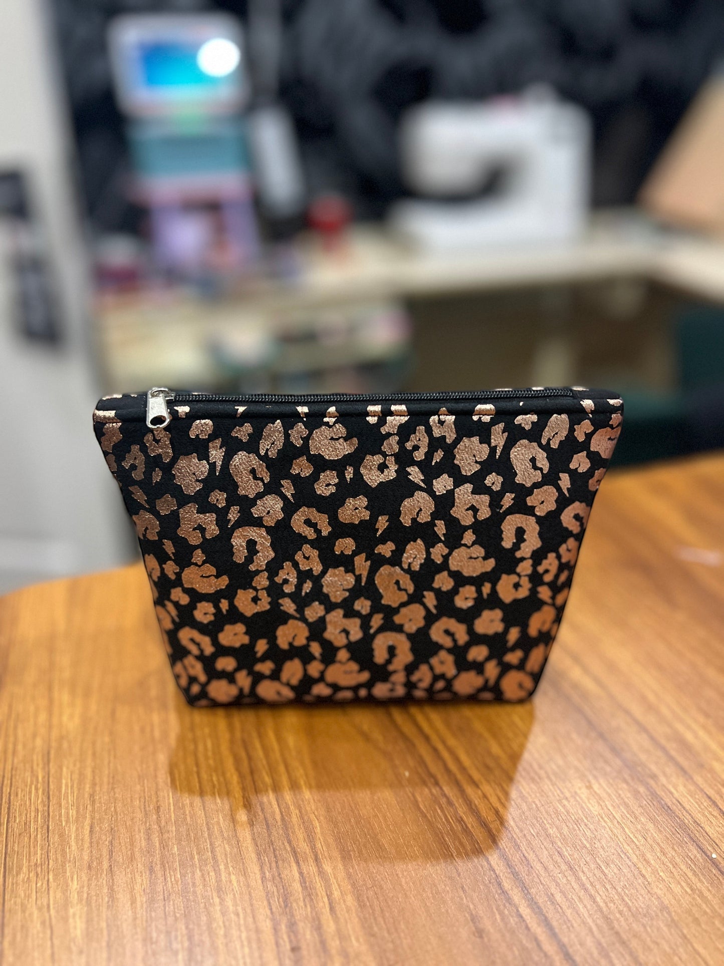 Sew Much Love black eco viscose mini cosmetic bag with gold leopard print and black zip.