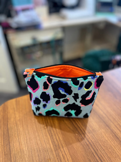 Sew Much Love khaki rainbow leopard print mini cosmetic bag with orange lining and zipper pull. Eco viscose material.