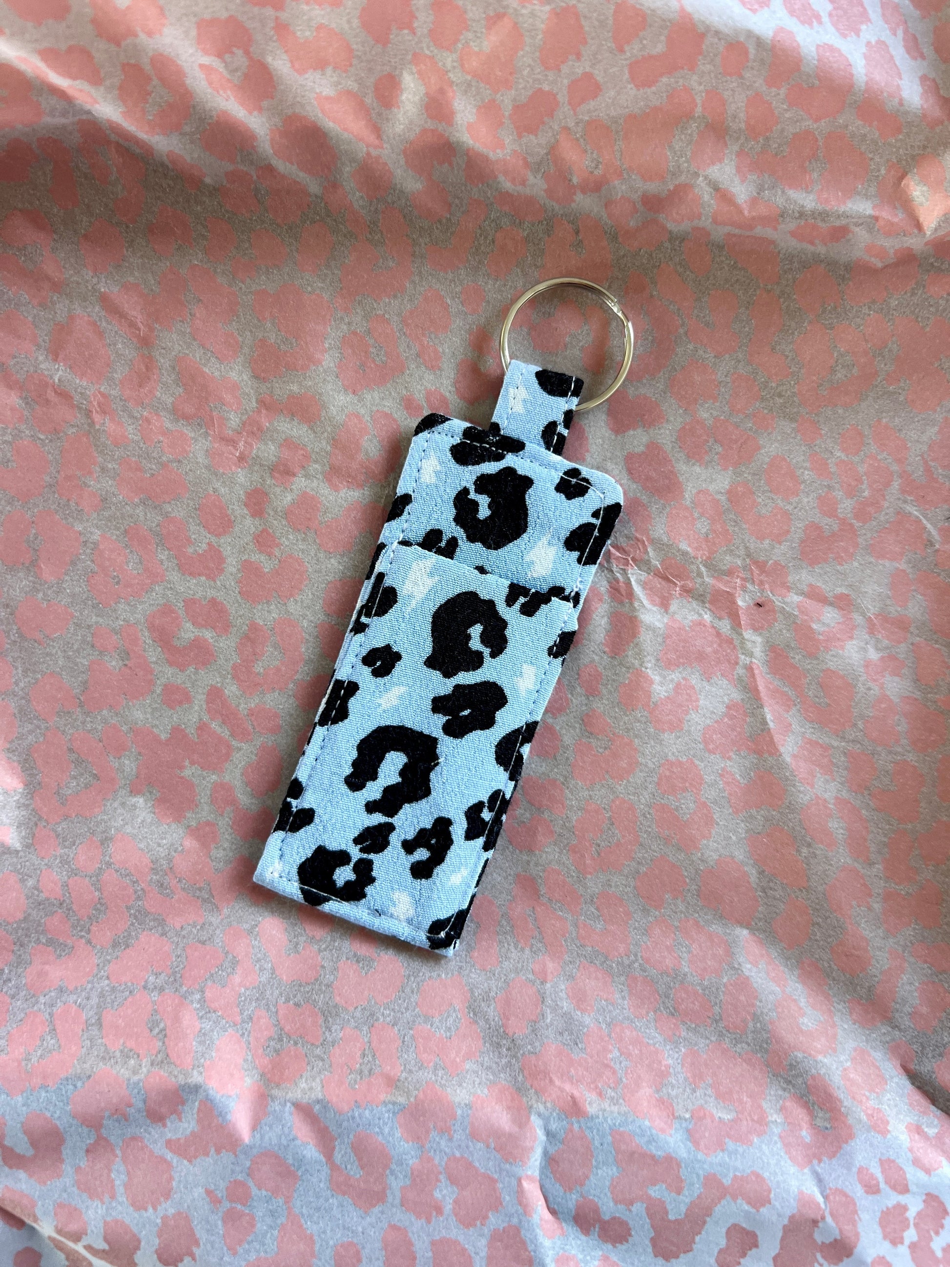 Sew Much Love light blue cotton lip balm holder with black leopard print and silver keyring.