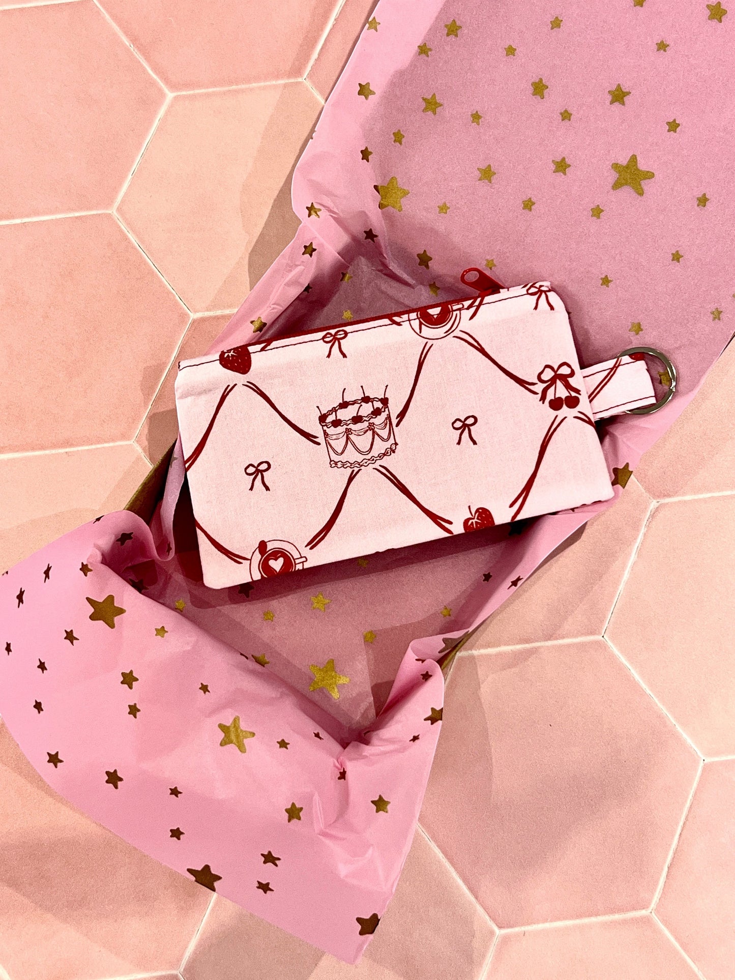 Sew Much Love pink fabric coin purse with cake, bow, and cherry print, featuring a keyring attachment.