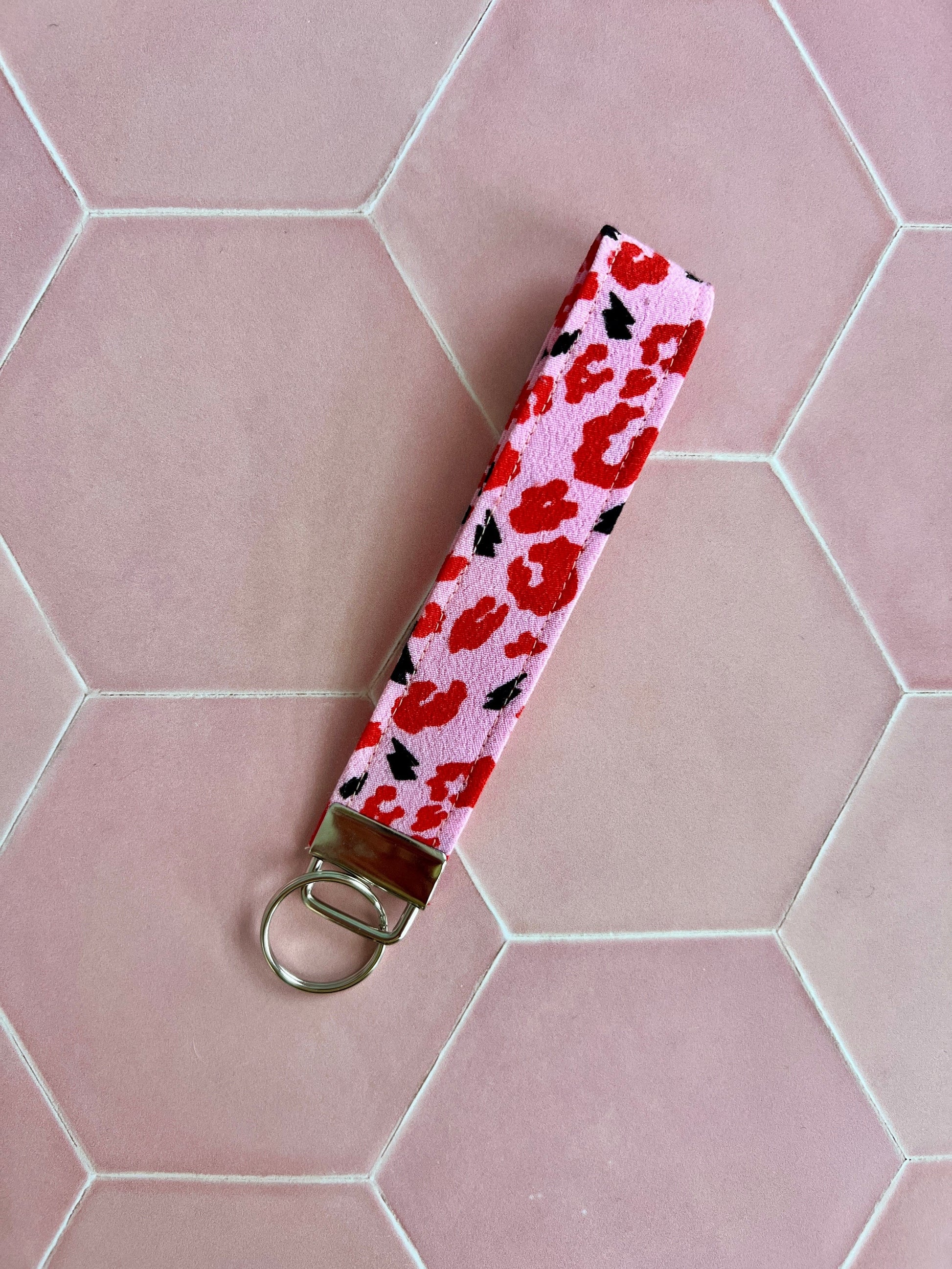 Sew Much Love pink wristlet keychain with red leopard print and black lightning bolts, silver hardware.