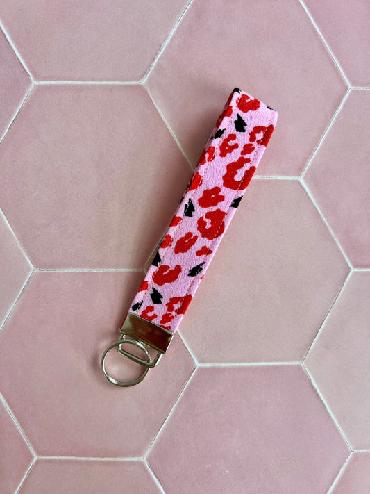 Sew Much Love pink wristlet keychain with red leopard print and black lightning bolts, silver hardware.